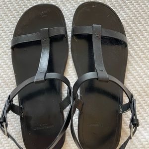 Saint Laurent black leather flat sandals.